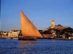 stone town zanzibar from the sea with traditional sailing craft